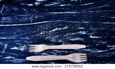 Silver fork lying on a wooden table.