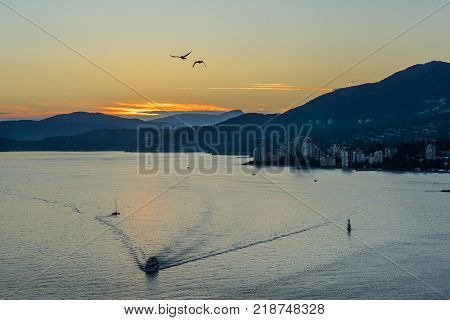 Sunset with Sea and Mountain View. Lions Gate Bridge Sunset and evening in Vancouver Canada.