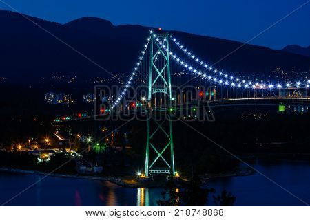 Lions Gate Bridge Sunset and evening of the beautiful town on Pacific Ocean in Vancouver Canada.