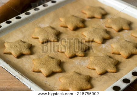 Baked gingerbread on baking sheet without decoration. Selective focus.