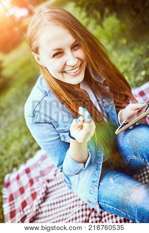 Girl Sitting In The Sunny Park. Picnik