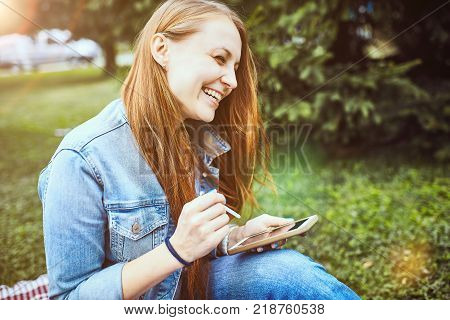 girl sitting in the sunny park. picnik