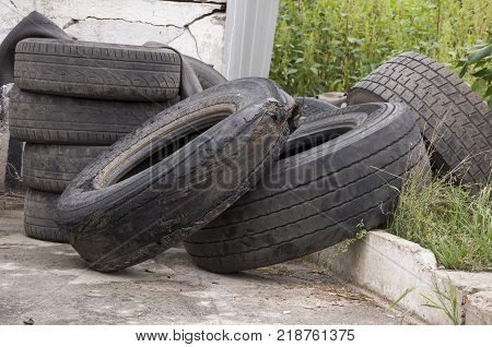 Service station for cars. Old tires on the yard