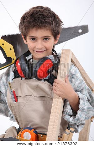 Young boy with adult carpenter's tools
