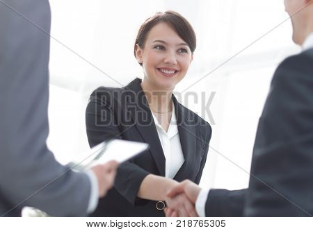 Businesswoman shaking hands with a businssman during a meeting