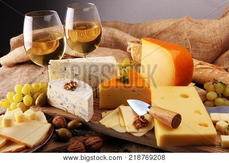 various types of cheese on rustic wooden table