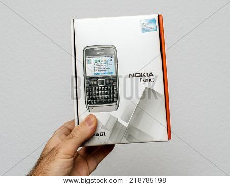 PARIS FRANCE - DEC 18 2017: Man holding against white background vintage and luxury NOKIA box of a E71 Business smartphone