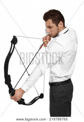 Young businessman practicing archery on white background