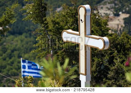 Cross and Greek flag in front of Tsambika Monastery (RHODES GREECE)