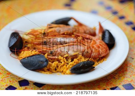 Royal Paella. Tasty Rice with king prawns and mussels