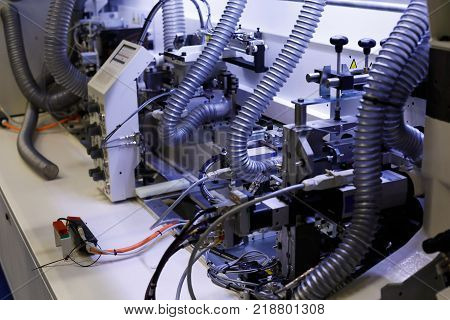 Part of the automatic edgebanding machine. Selective focus.