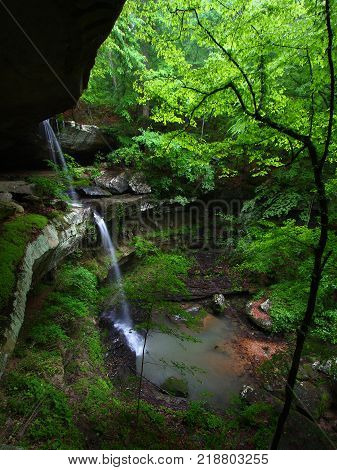 Waterfall flows into a deep canyon in the woodland of northern Alabama
