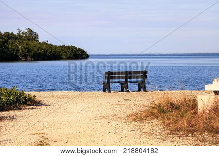 Secluded bench overlooking a large wetland marsh in the Ding Darling National Refuge on Sanibel Island Florida