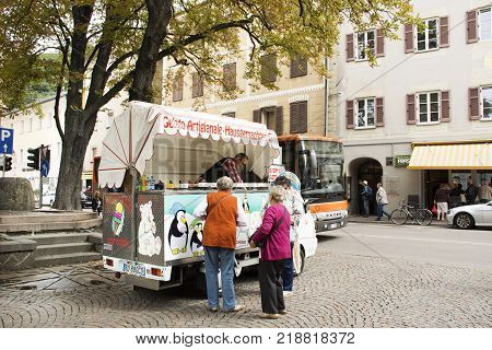 Italian people and foreigner travellers buying ice cream Italian style from food truck and travel street market at Meran city on September 2 2017 in Merano Italy