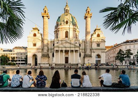 Vienna, Austria - August 15, 2017: Karlskirche or Church of St Charles is a baroque church located on the south side of Karlsplatz in Vienna. Unidentified tourists enjoying the views