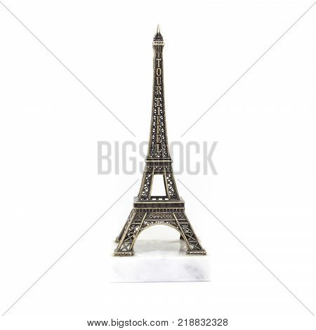 Paris Eiffel tower miniature on the marble stand isolated on white background