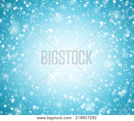 Light blue winter abstract background with snowflakes.