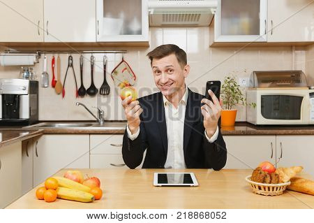 Perturbed Young Business Man In Suit, Shirt, Having Breakfast, Sitting At Table With Tablet, Spreadi