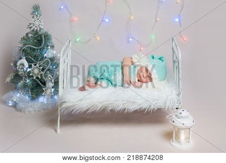 Newborn boy sleeping on small cot