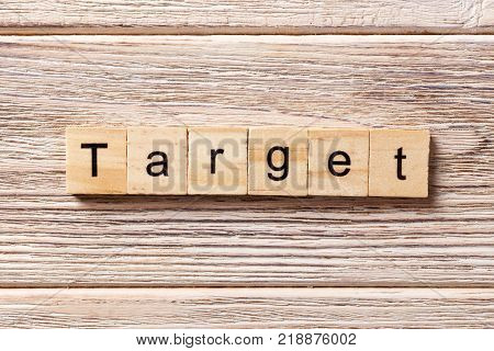 target word written on wood block. target text on table concept.