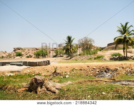 View of ancient ruins on Hemakuta hill in Hampi, Karnataka, India. Landscape with unique mountain formation with amazing stones, tropical nature and temple. UNESCO World Heritage Site