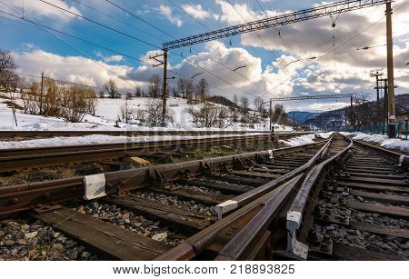 old railroad in winter mountain on a cloudy day. transportation background