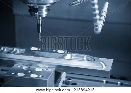 The CNC milling machine cutting the sample part.The end-mill tool cutting the mold part by CNC milling machine.