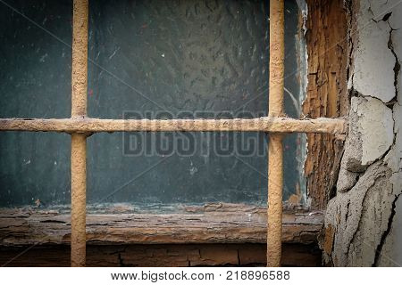 Window with window bars on a rundown house