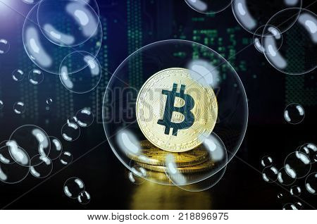 Bitcoin in a soap bubble. Cryptocurrency physical golden bitcoin coins.