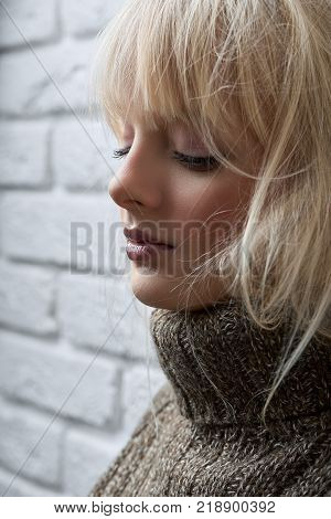 Cropped vertical close up of an attractive young woman posing elegantly near the wall with her eyes closed copyspace beauty makeup natural charming relaxed harmony peaceful.