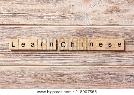 Learn chinese word written on wood block. Learn chinese text on table concept.