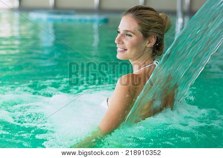 Beautiful attractive woman enjoying time in spa pool