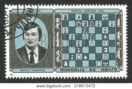 Mongolia - CIRCA 1986: Stamp printed by Mongolia Multicolor edition offset printing on topic of Chess Champions shows Karpov USSR and winning game on a chessboard