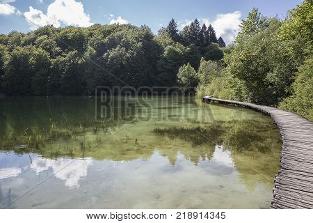 Landscape With Wooden Track Over The Water At  