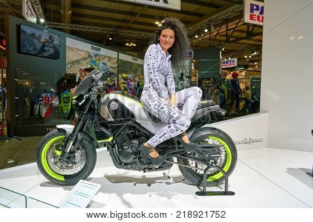 MILAN, ITALY - NOVEMBER 11, 2017: a model poses for the visitors during the EICMA 2017 - 75th International Motorcycle Exhibition.