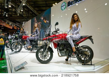 MILAN, ITALY - NOVEMBER 11, 2017: a model poses for the visitors during the EICMA 2017 - 75th International Motorcycle Exhibition.