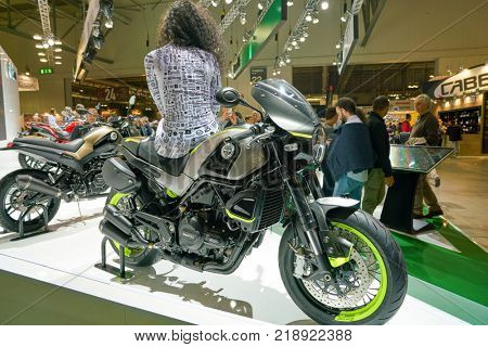 MILAN, ITALY - NOVEMBER 11, 2017: a model poses for the visitors during the EICMA 2017 - 75th International Motorcycle Exhibition.