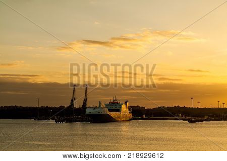 Sunset with cargo ship in UK harbour