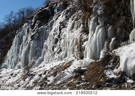 Big icefall in mountain at nice sun day. Winter in Georgia.