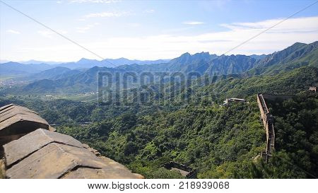 Panorama of Chinese great wall with nature landscape background. China Great wall, hiking route around Simatai section, one of the most impressive and less touristic part of the Great Wall. Great Wall sunset over mountains in Beijing, China.
