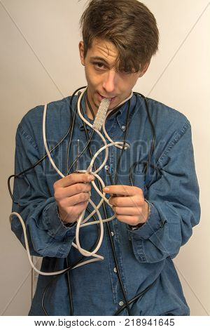 construction worker electrician trying to figure out what to do in a mess of cables