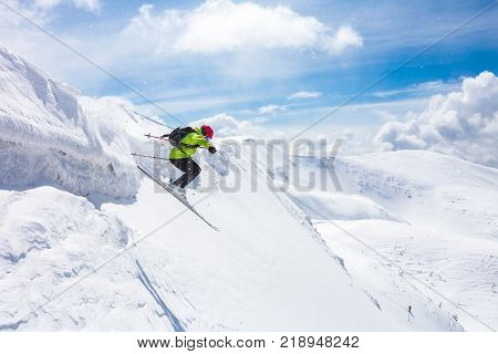 skier standing on top snow sunny day in Carpathian mountains Ukraine