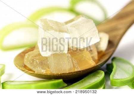 Aloe Vera Gel in Wooden Spoon with Aloe Vera Leaves on White Background. Aloe Vera gel almost use in food medicine and beauty industry.