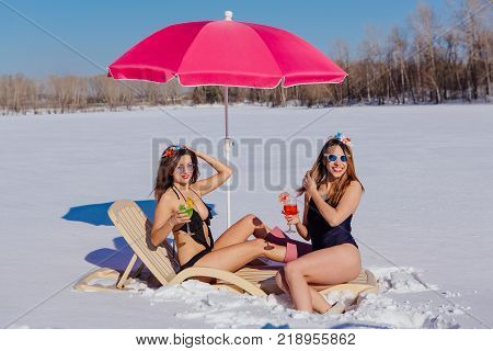 Novokuznetsk, Kemerovo region, Russia - 23 Feb, 2017 : White beaches of Siberia is an enterteiment activity where people playing beach games dressed in bikini in winter. Women in bikini with cocktails