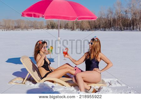 Novokuznetsk, Kemerovo region, Russia - 23 Feb, 2017 : White beaches of Siberia is an enterteiment activity where people playing beach games dressed in bikini in winter. Women in bikini with cocktails