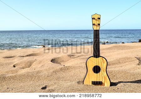 Photo Picture of a Guitar on the Sand Beach