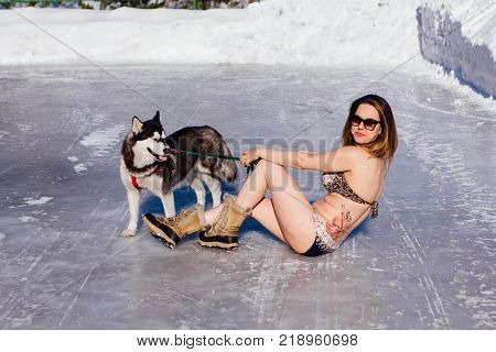 Novokuznetsk, Kemerovo region, Russia - 23 Feb, 2017 : White beaches of Siberia is an enterteiment activity where people playing beach games dressed in bikini in winter. Women in bikini with husky