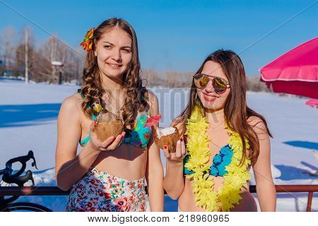 Novokuznetsk, Kemerovo region, Russia - 23 Feb, 2017 : White beaches of Siberia is an enterteiment activity where people playing beach games dressed in bikini in winter. Women in bikini with cocktails