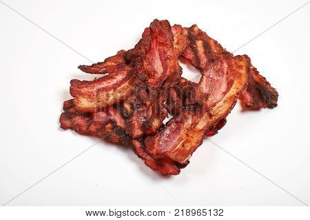 Three cooked, crispy fried bacon isolated on a white background