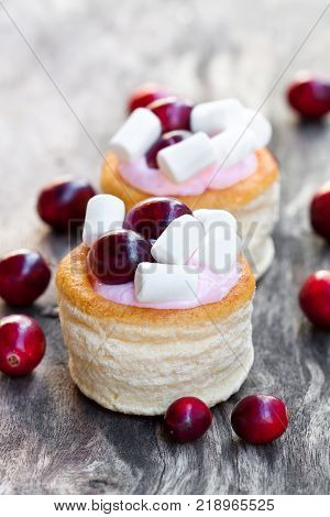 puff pastry stuffed with fruity soft cream cheese and cranberry on wooden background